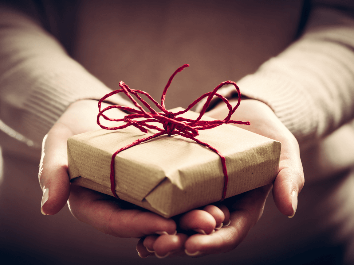girl holding out gift