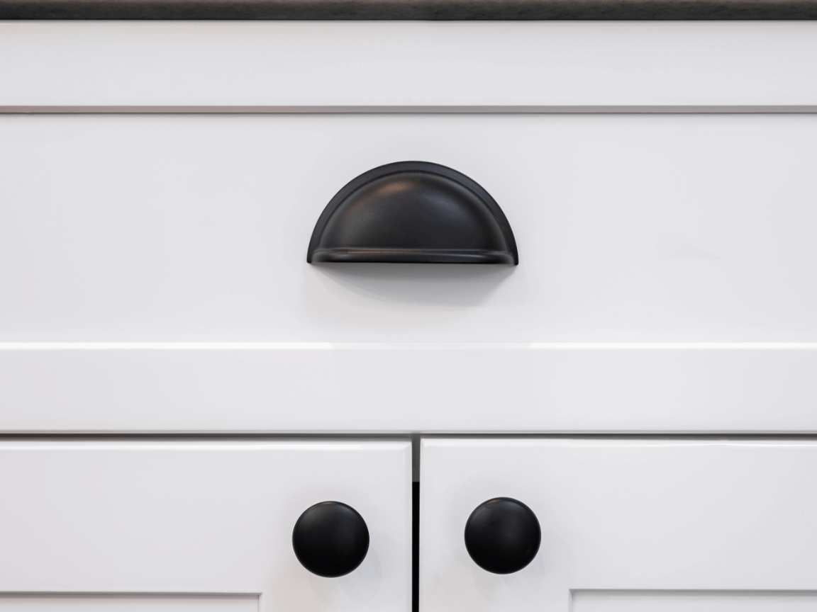 white kitchen cupboards with black cabinet hardware
