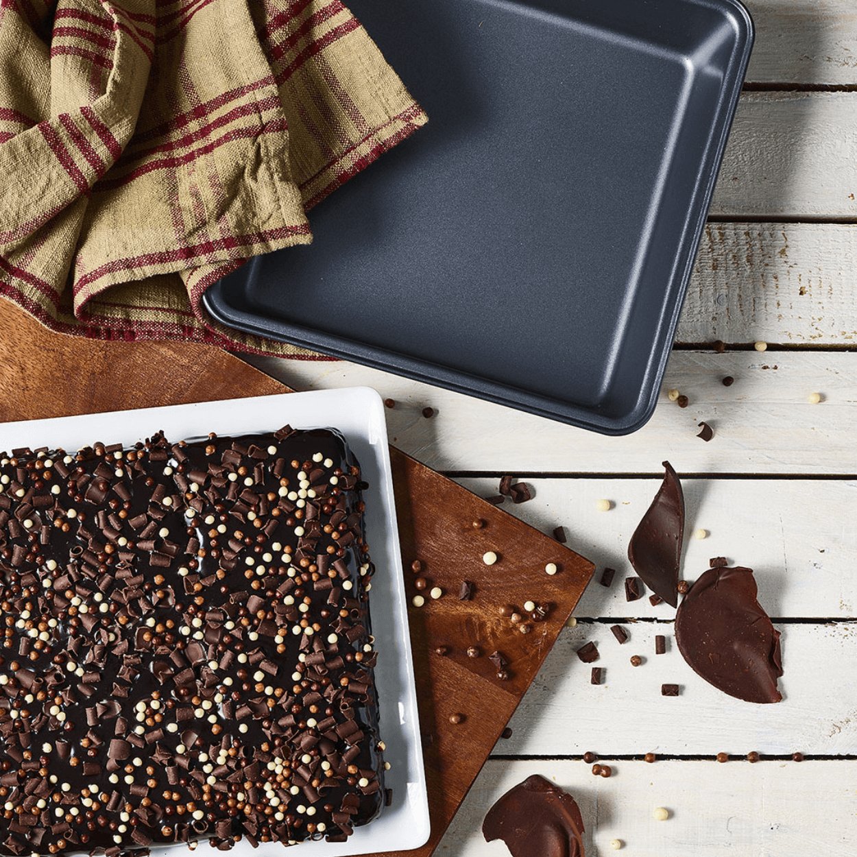 steel square mould next to chocolate dessert