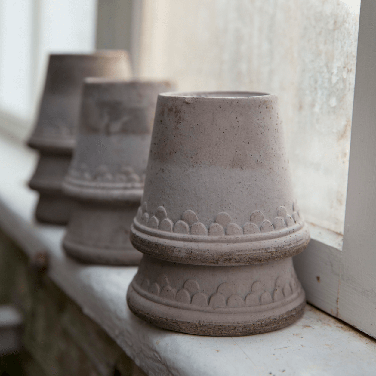 grey copenhagen plant pots on windowsill 