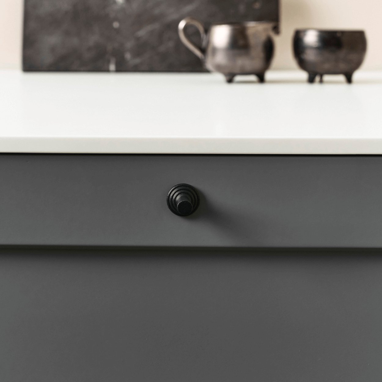motion cast iron knob fixed to kitchen cabinet