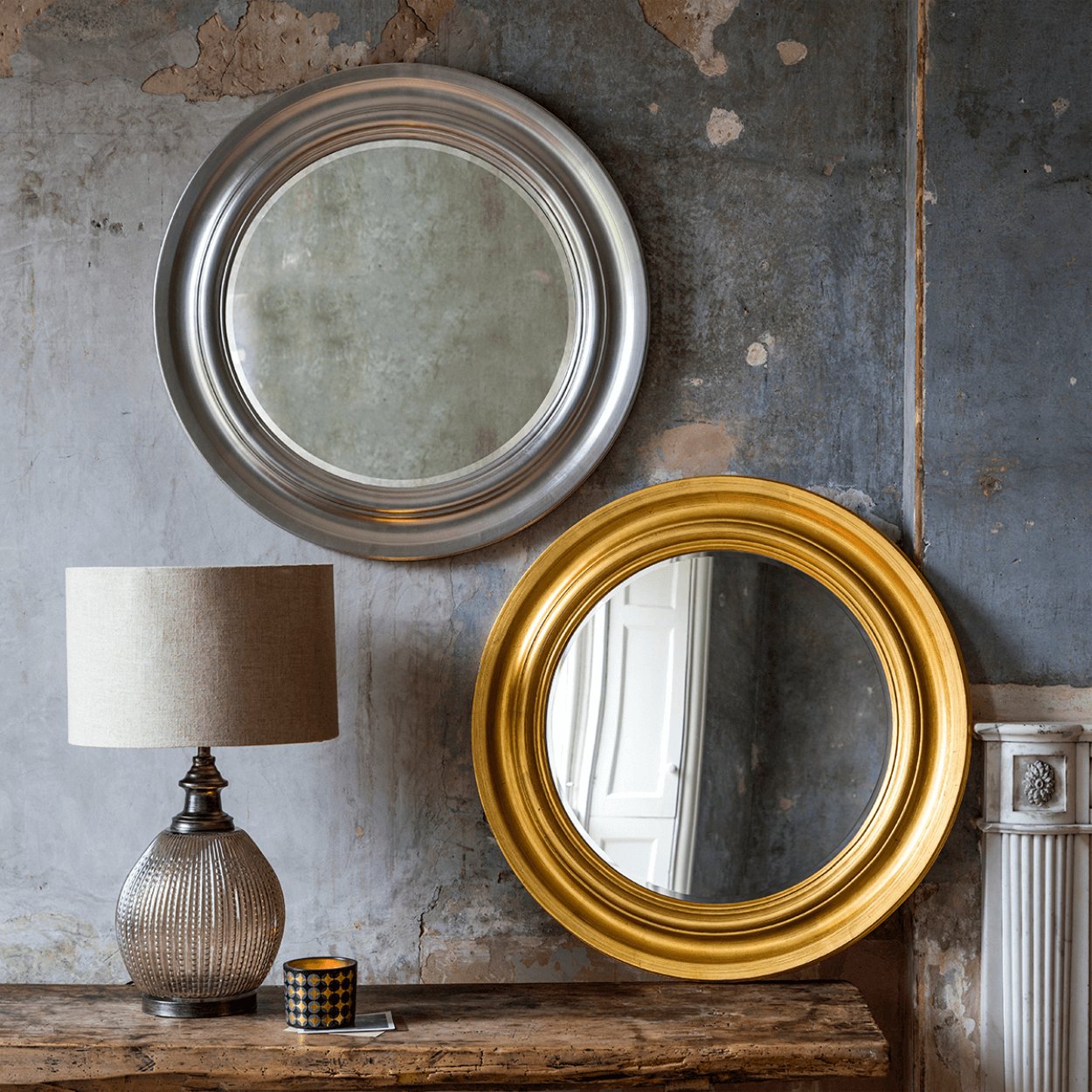 round silver and gold mirror next to one another